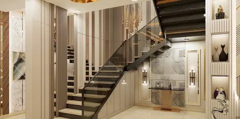The staircase sits against the same fluted panelling, so it belongs to the room rather than interrupting it.